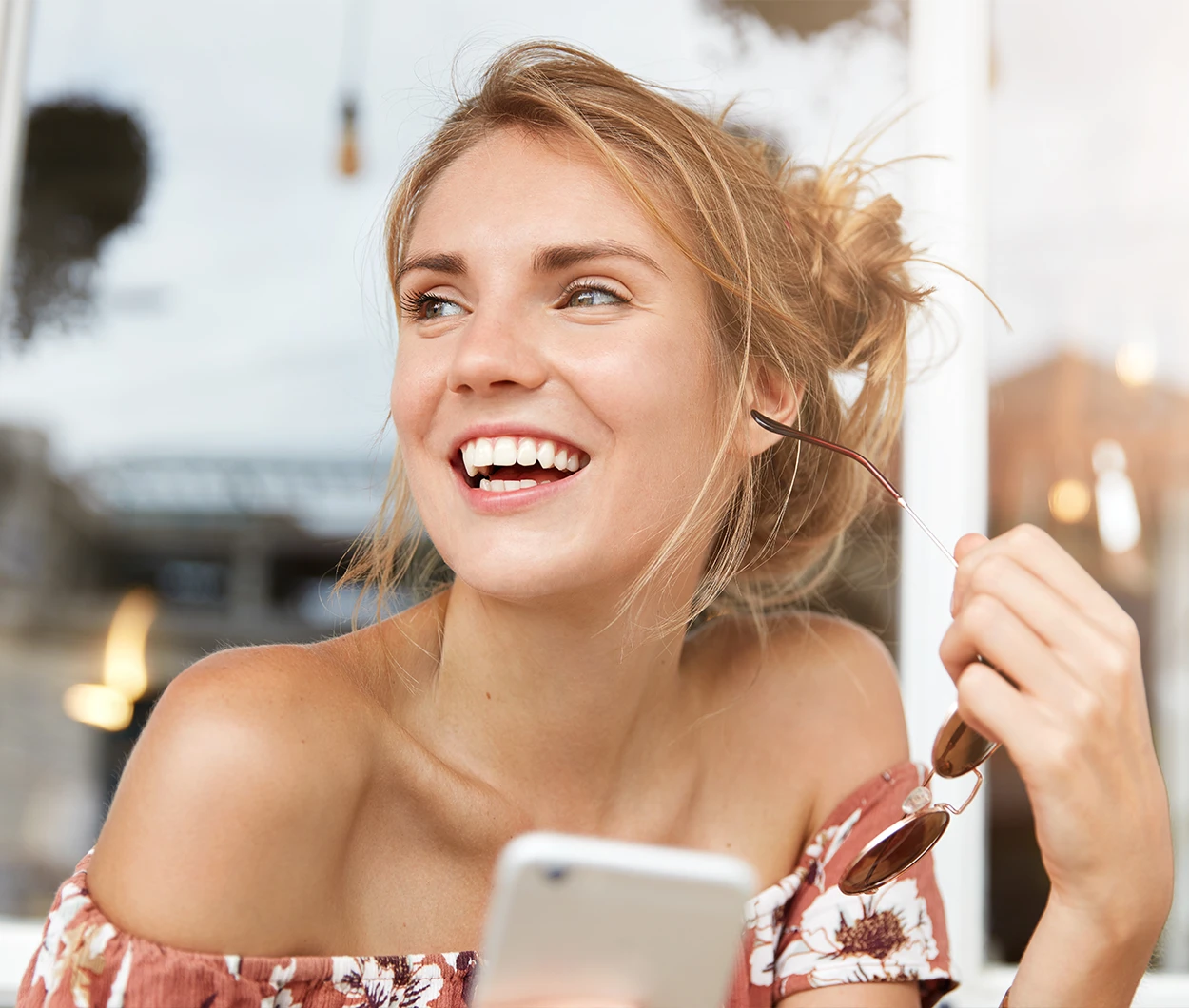 Smiling woman outdoors representing TMJ relief and jaw pain treatment